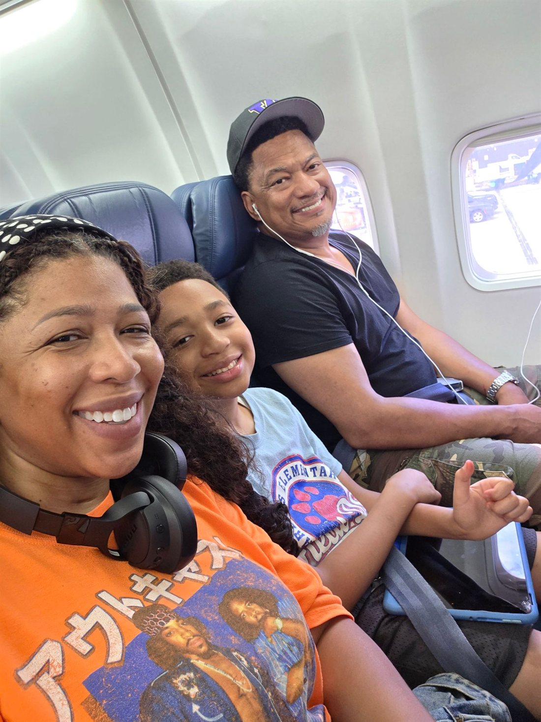 Curtis, Jozette, and their child on the early-morning flight to Panama.